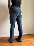 Load image into Gallery viewer, 00's Dolce & Gabbana "Don't Touch" low-rise flared jeans• Size 8
